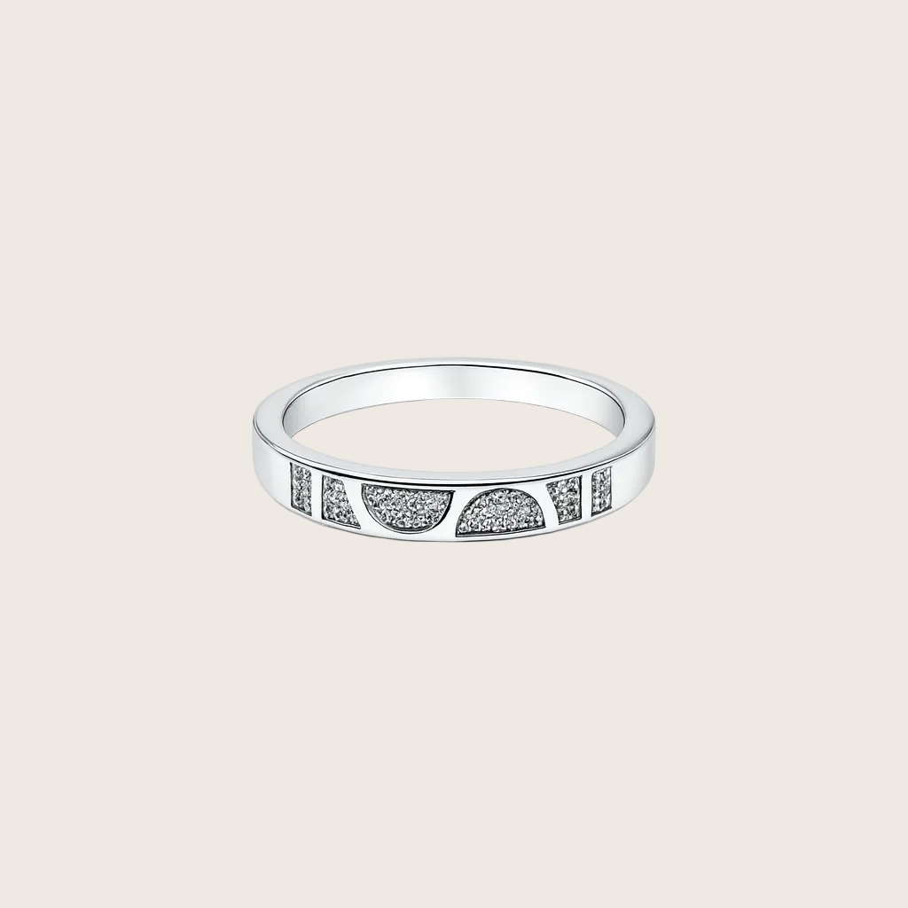 Silver ring with embedded stones on a white background