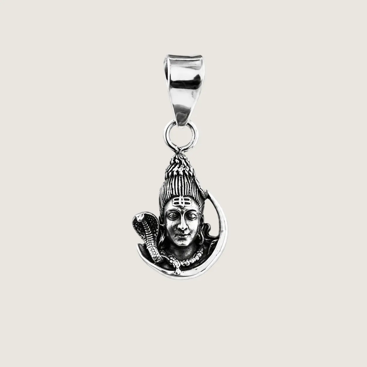 Silver pendant with a face design on a beige background