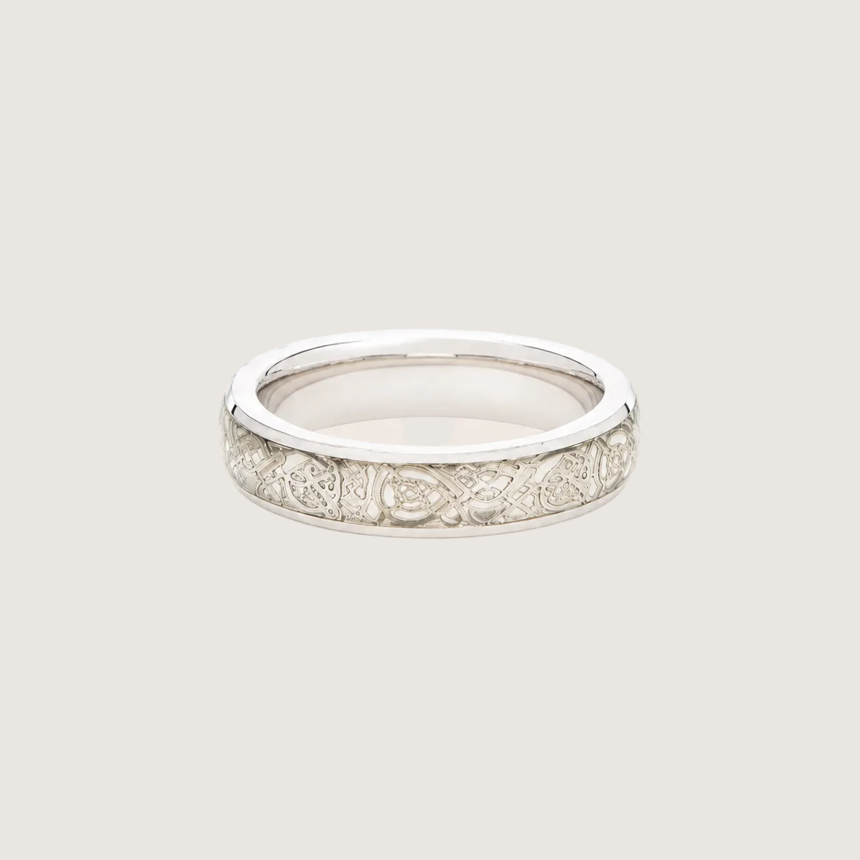 Silver ring with diamond accents on a beige background