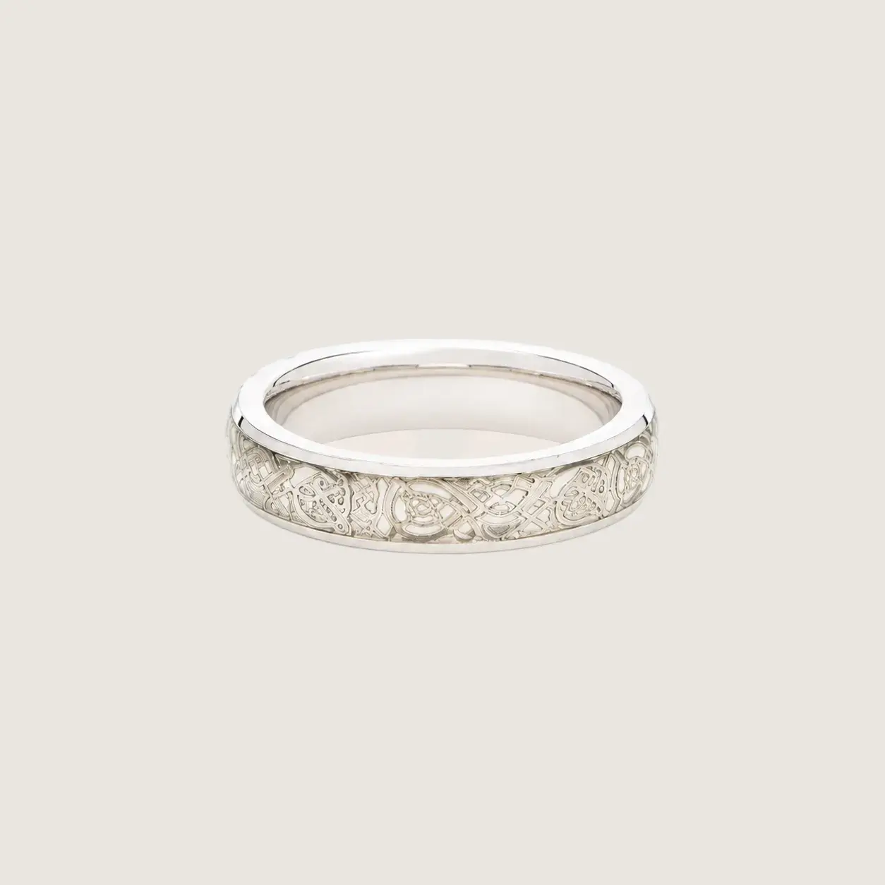Silver ring with diamond accents on a beige background