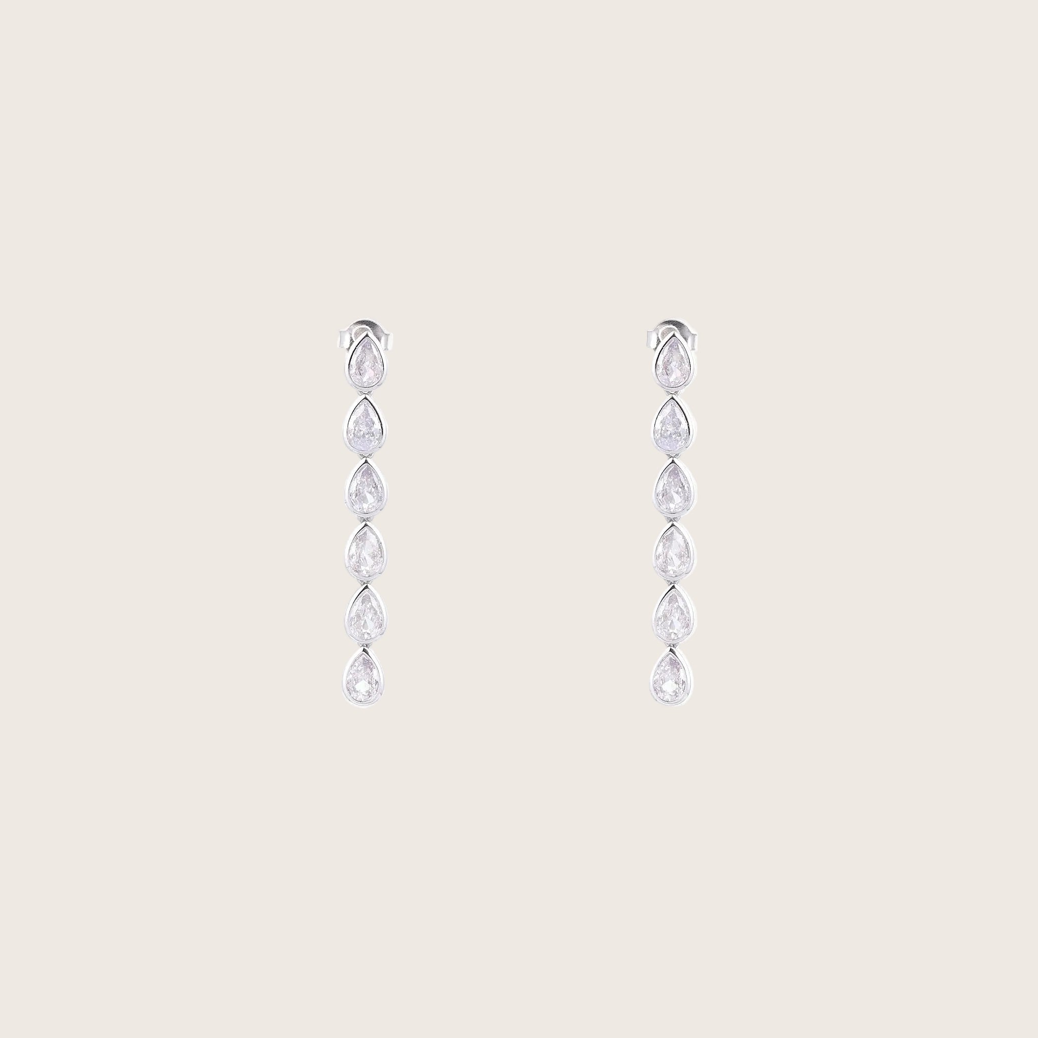 Pair of silver drop earrings with clear gemstones on a white background