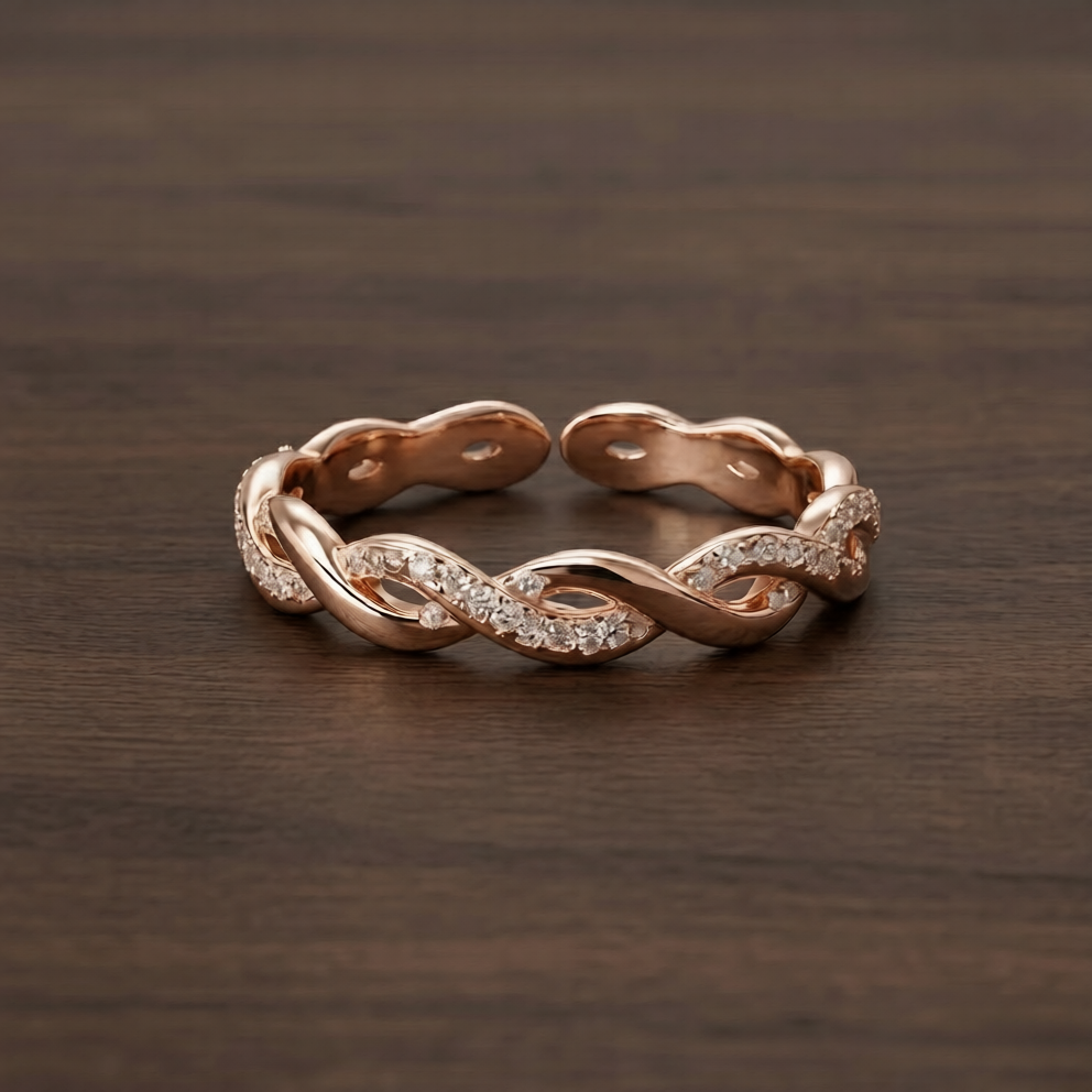 Rose gold ring with intricate design on a wooden surface