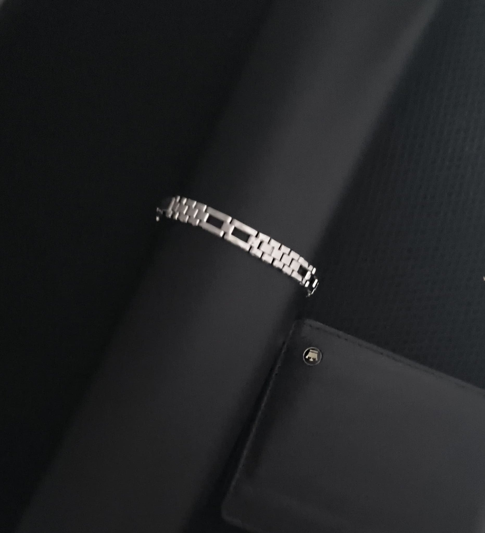 Close-up of a black car seat with a visible brand logo on a white background