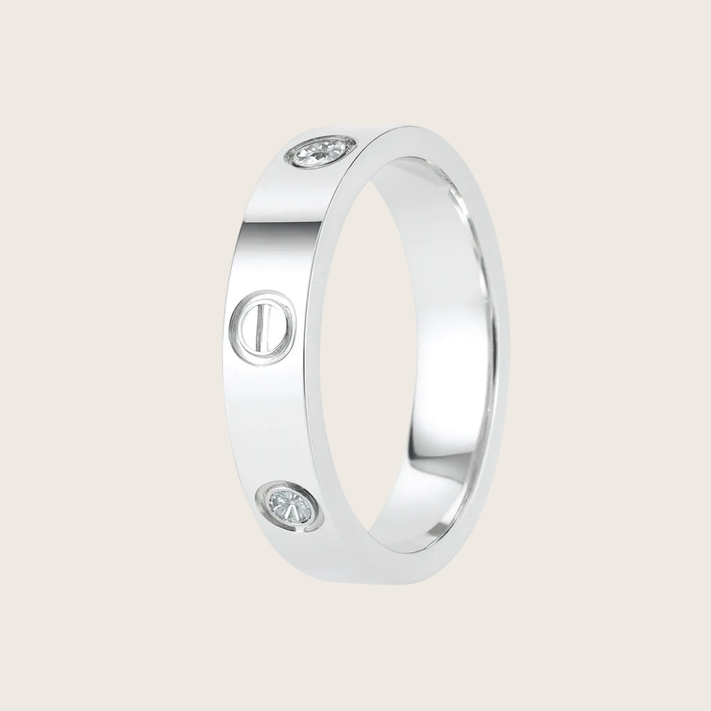 Silver ring with embedded stones on a white background, featuring the brand 'TRISHNHA'.