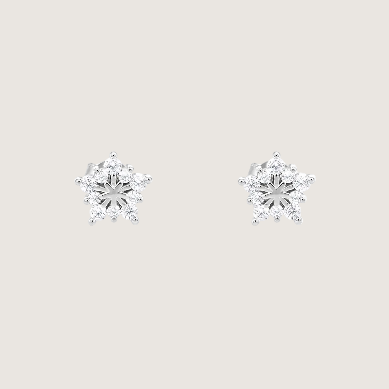 Pair of diamond snowflake earrings on a white background
