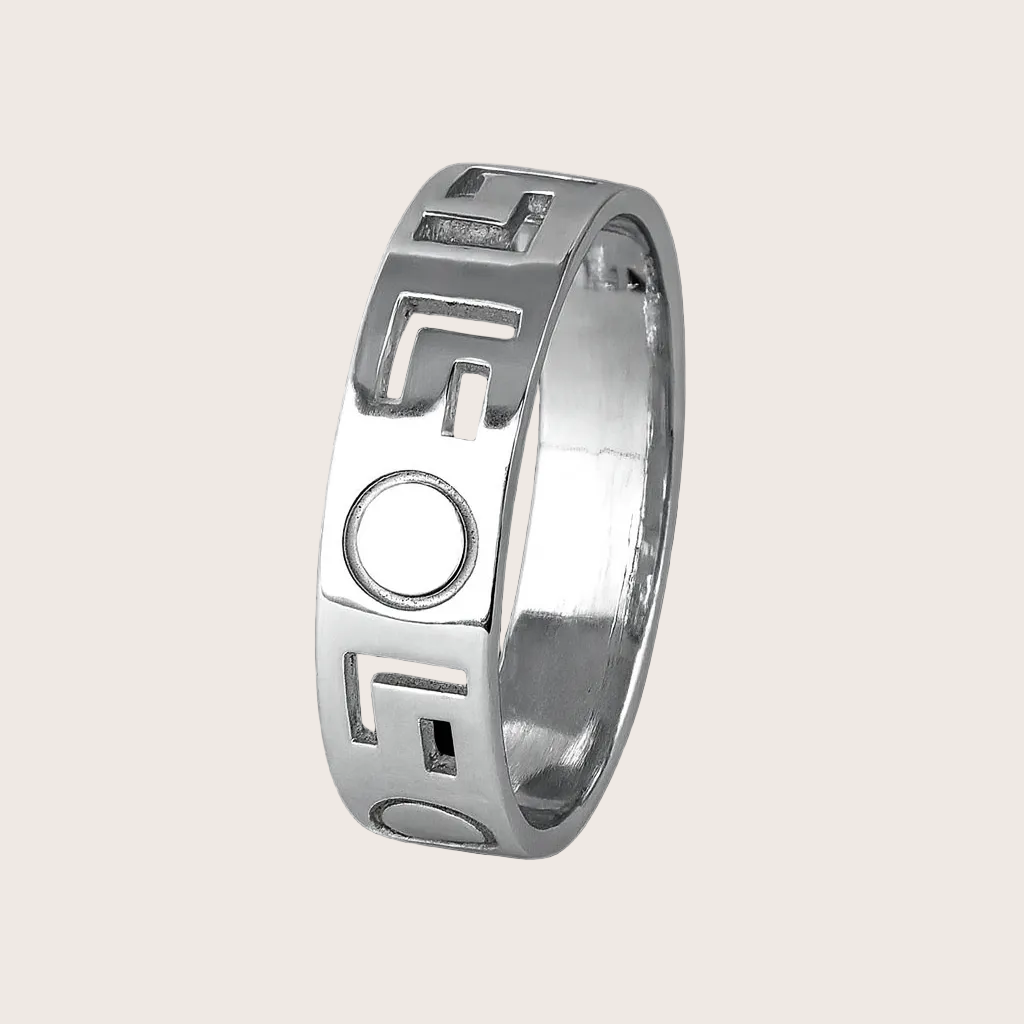 Silver ring with geometric design on a black background
