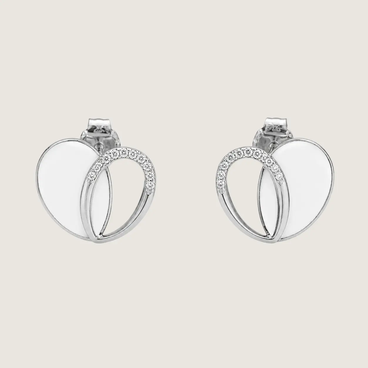 Pair of silver hoop earrings with small diamonds on a light beige background