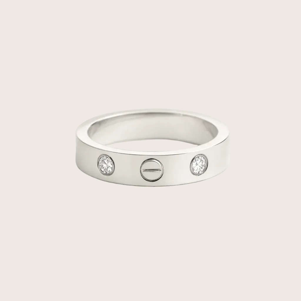 Silver ring with three circular gemstones on a light gray background