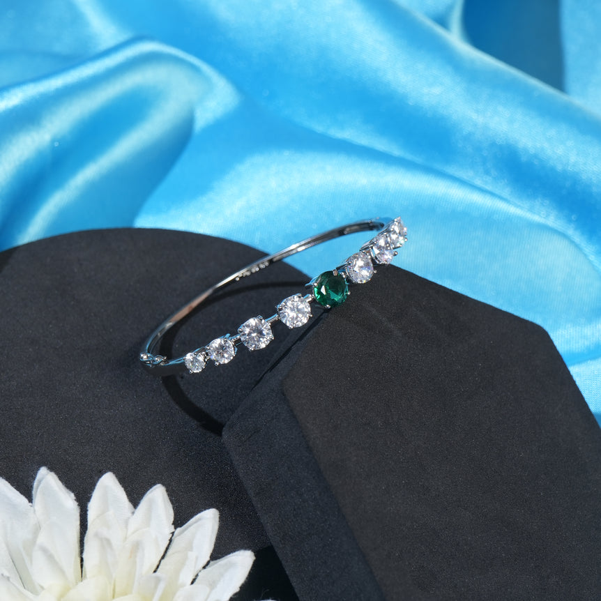 silver bracelet with sparkling green stone