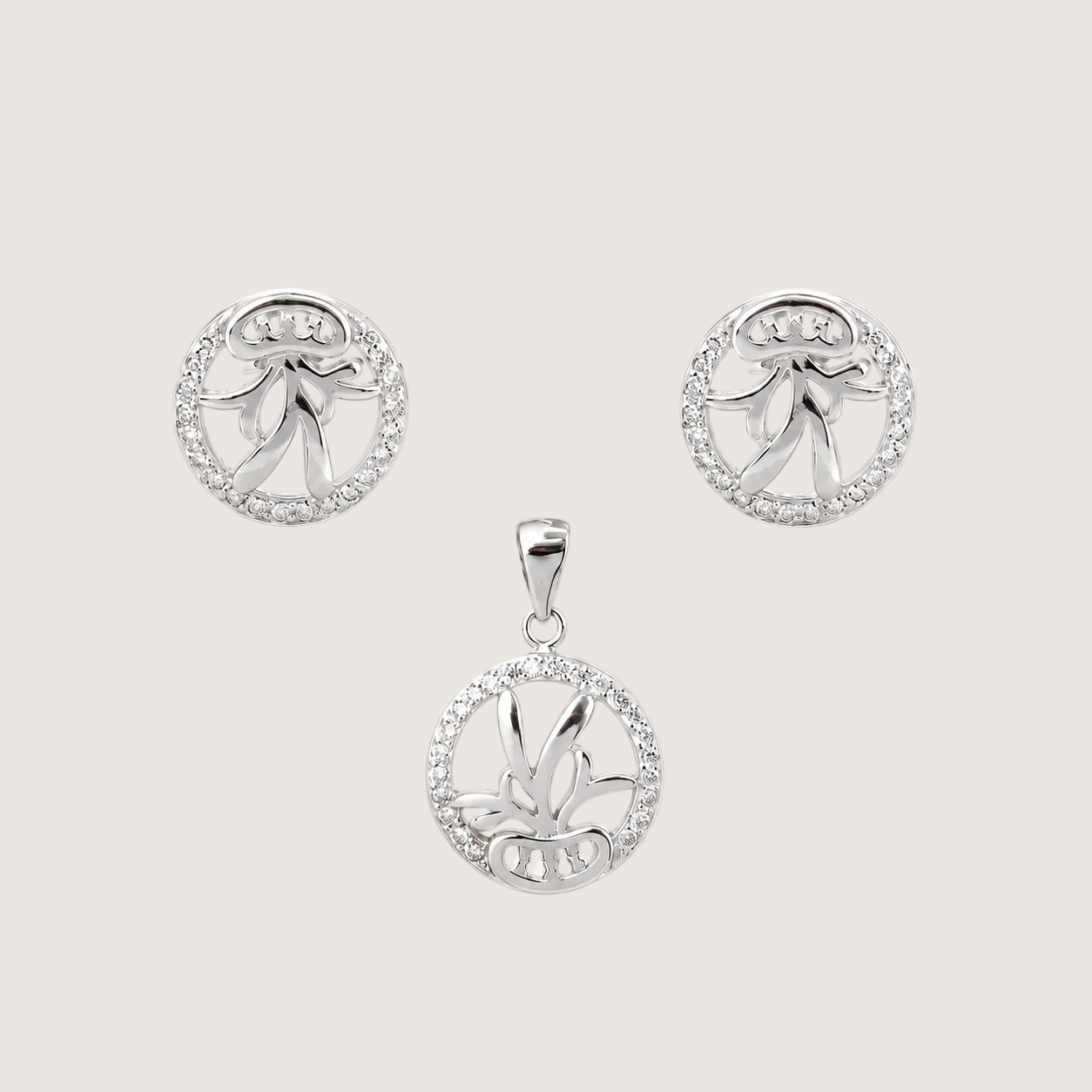 Silver jewelry set with pendant and earrings on a light beige background