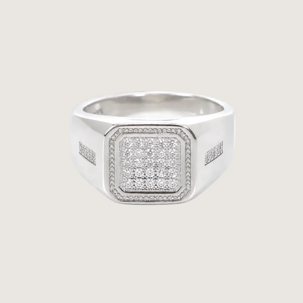 Silver ring with diamond accents on a light gray background