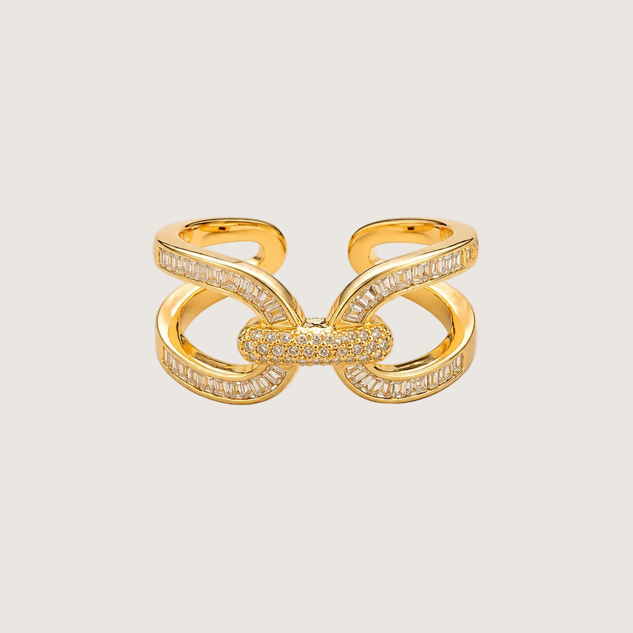 Gold butterfly-shaped ring with diamond accents on a light beige background