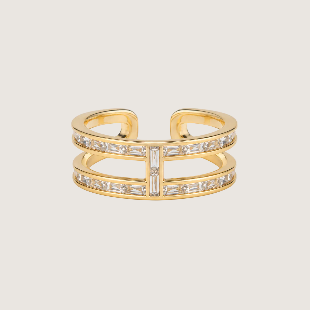 Gold ring with diamond accents on a light beige background