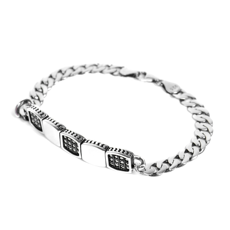 silver men bracelet with black and silver rectangular pattern