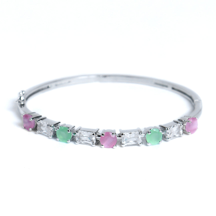 silver bracelet with sparkling green and pinkish stone