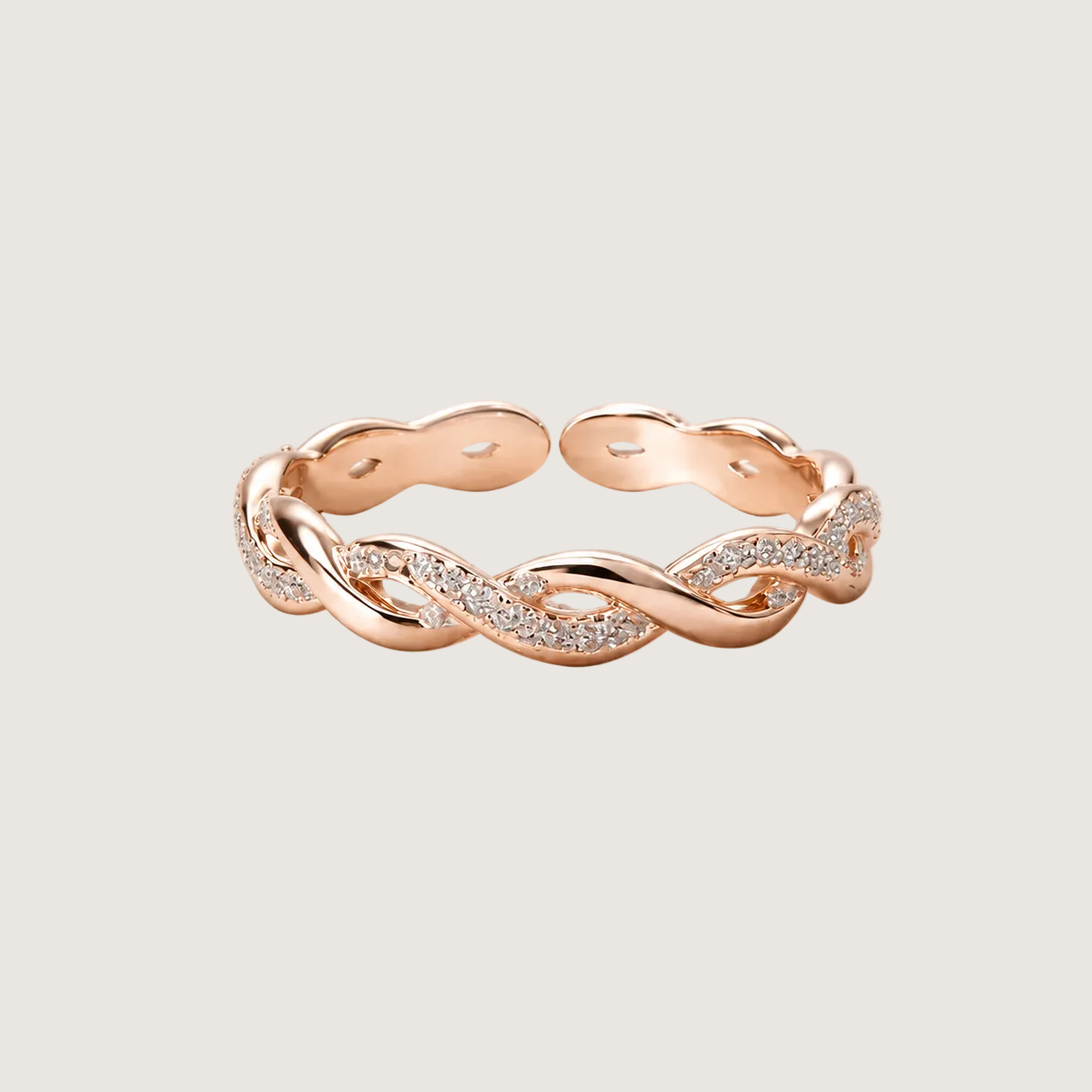 Rose gold ring with diamond accents on a light beige background