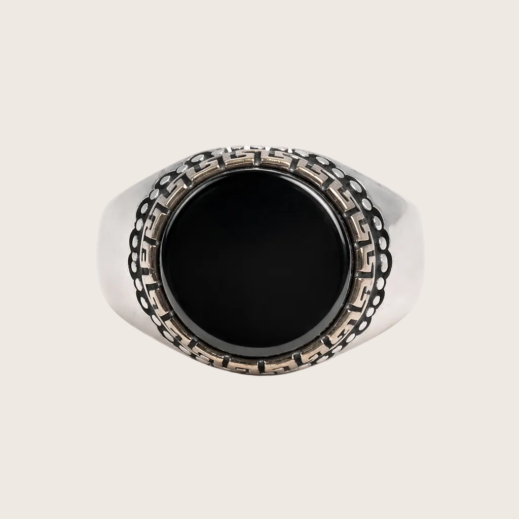 Silver ring with black stone on a white background