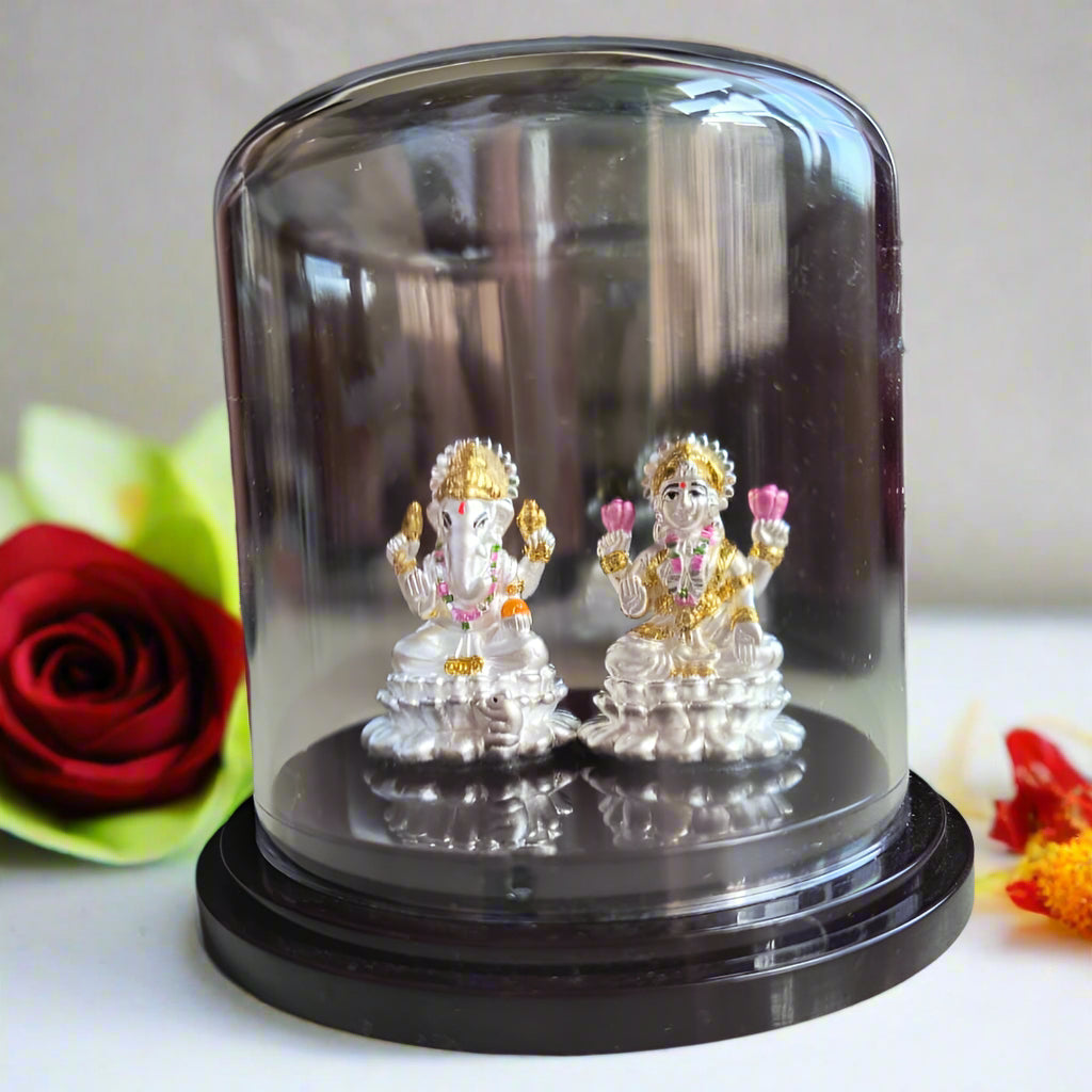Decorative figurines in a clear glass dome on a wooden base