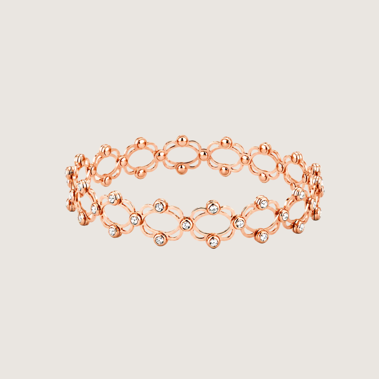 Rose gold bracelet with small diamonds on a light beige background