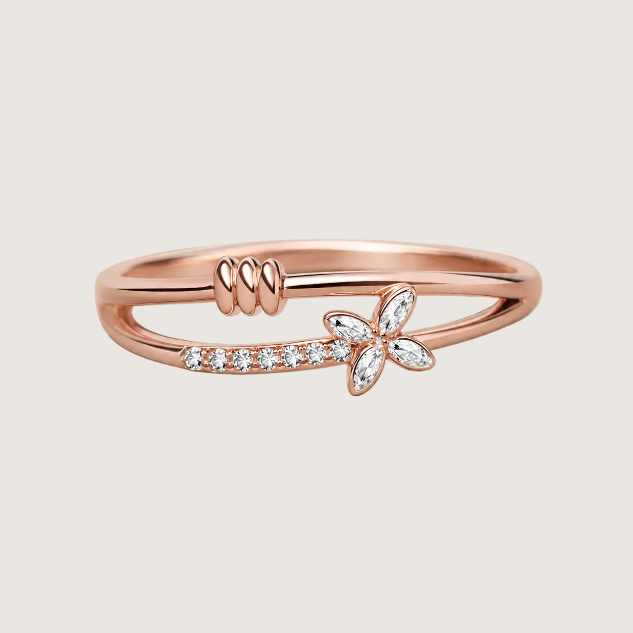 Rose gold ring with diamond accents on a light beige background