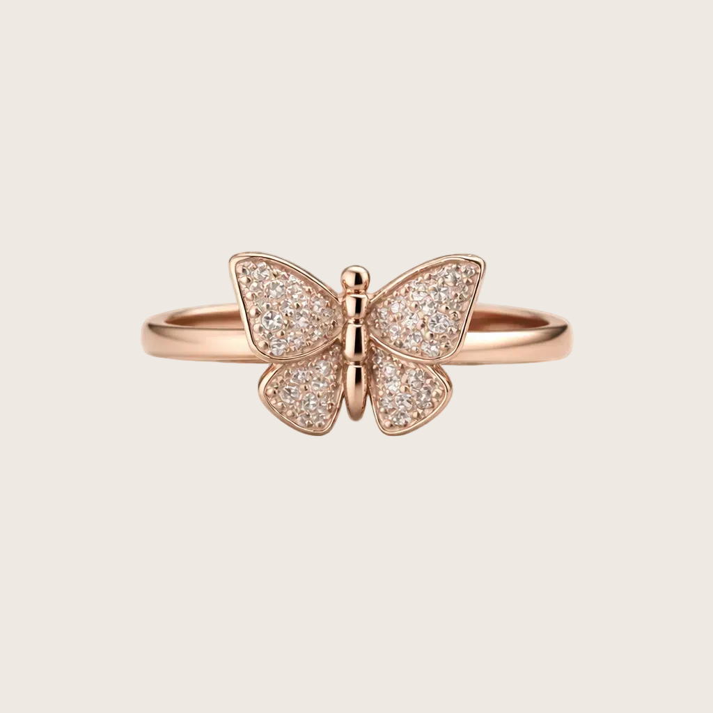 Rose gold butterfly ring with diamond accents on a light background