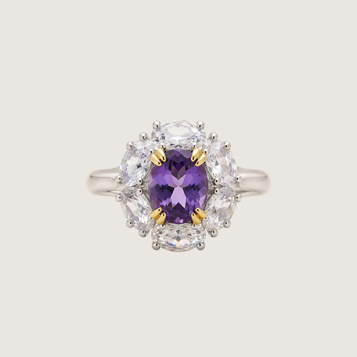 Ring with a purple gemstone and diamond accents on a beige background