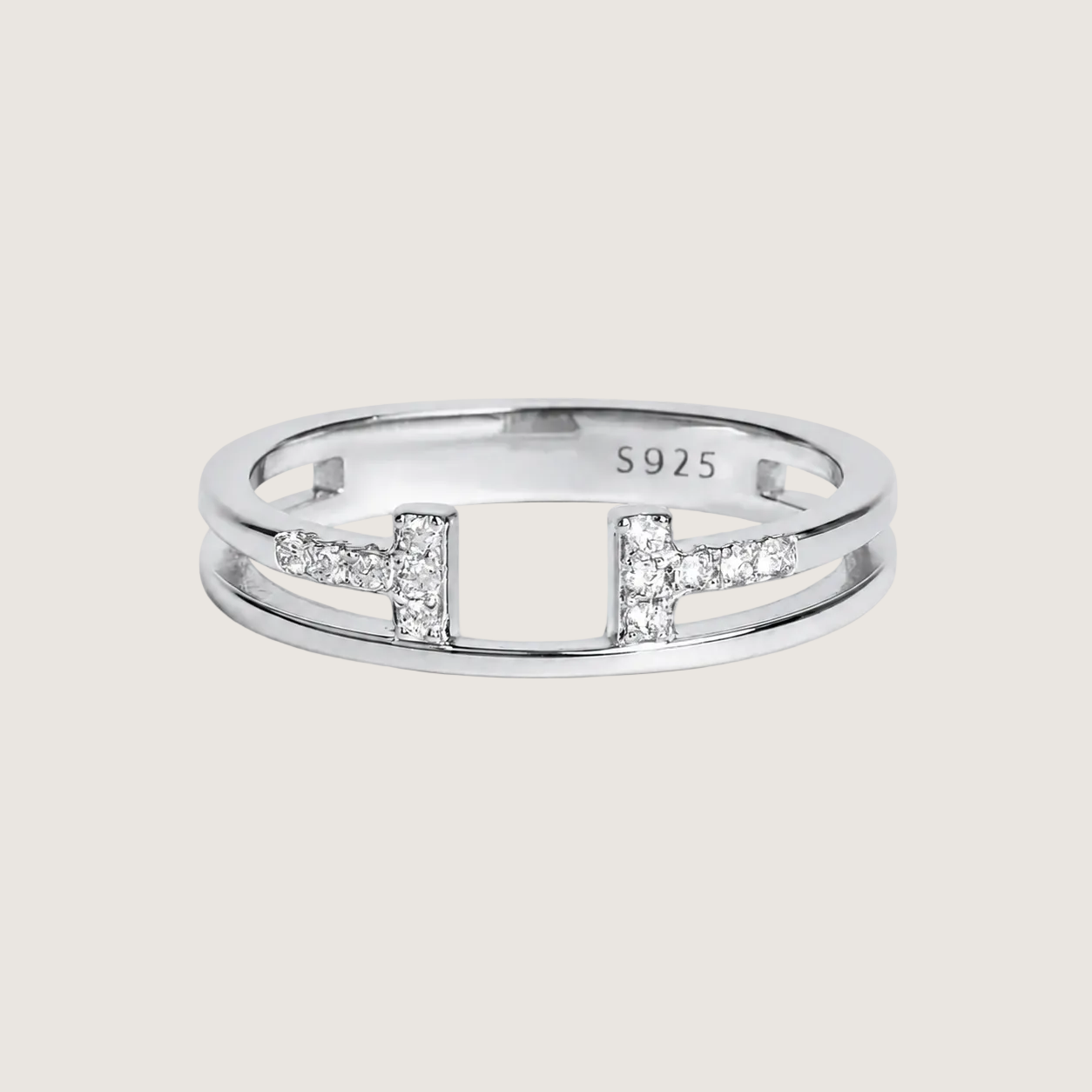 Silver ring with diamond accents on a light beige background