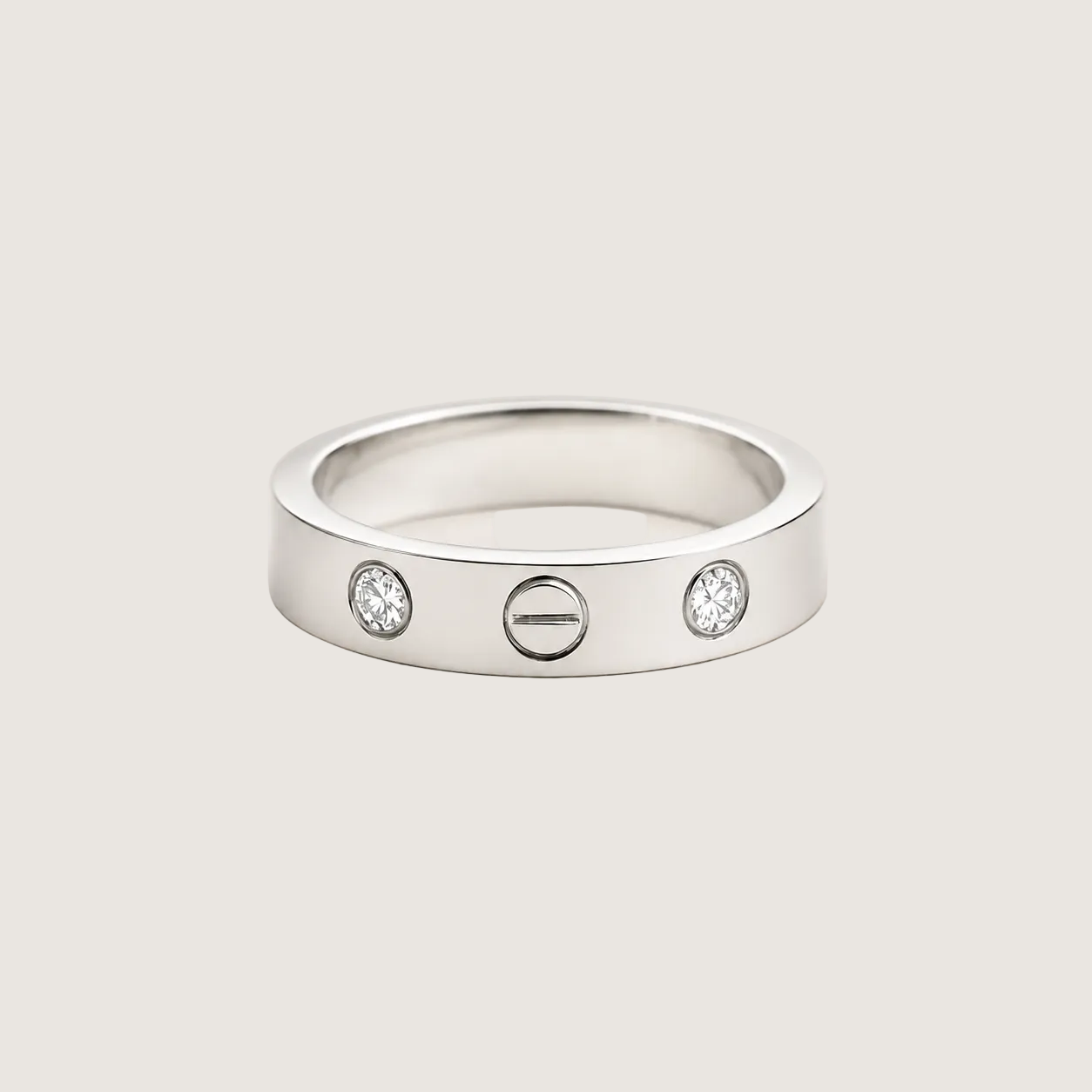 Silver ring with three circular elements on a beige background