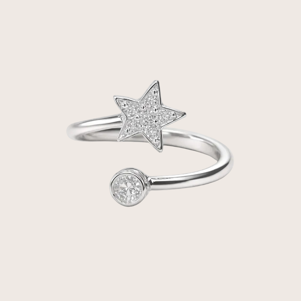 Silver open ring with star and round diamond designs on a white background