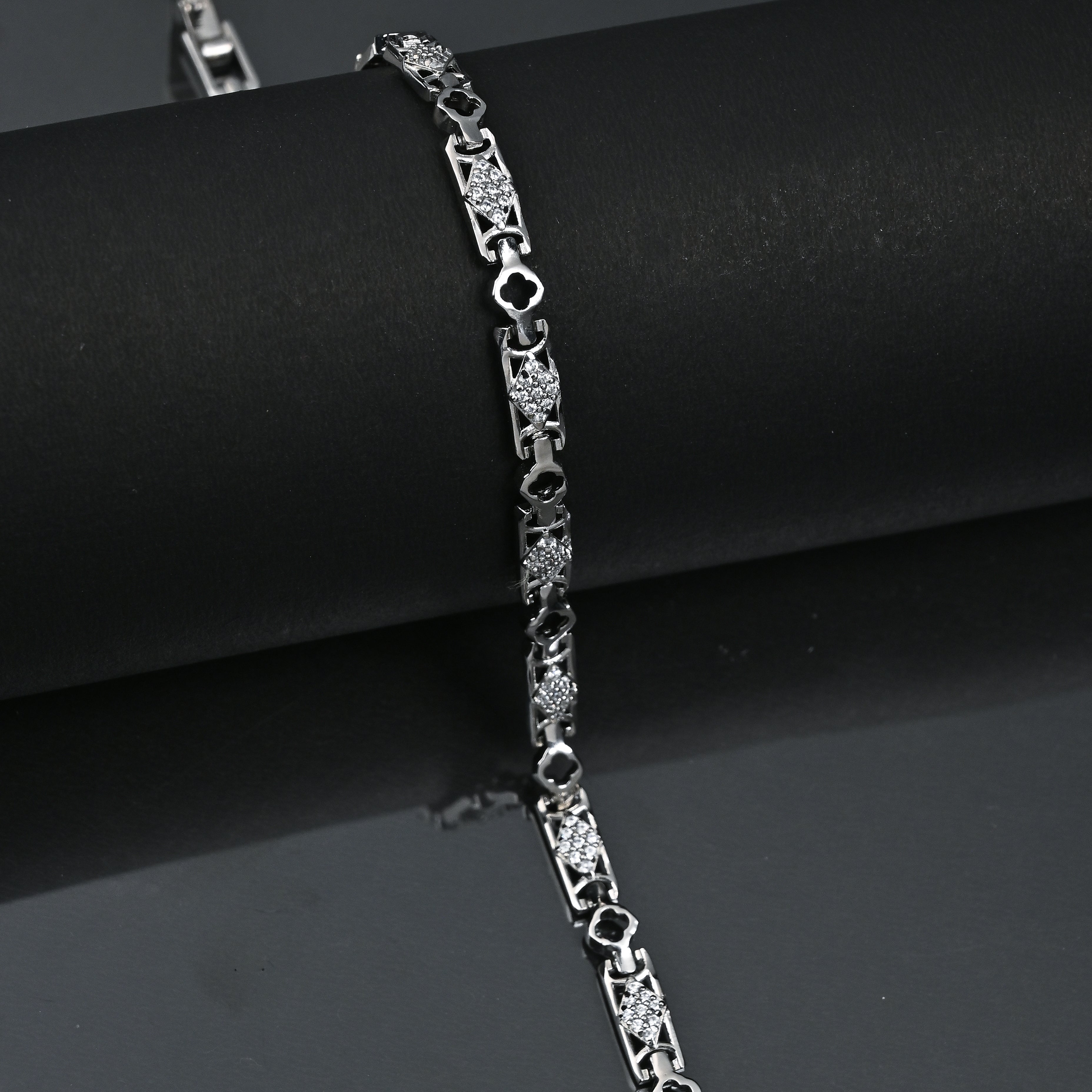 Silver bracelet on a black surface with 'TRISHHNA' branding.