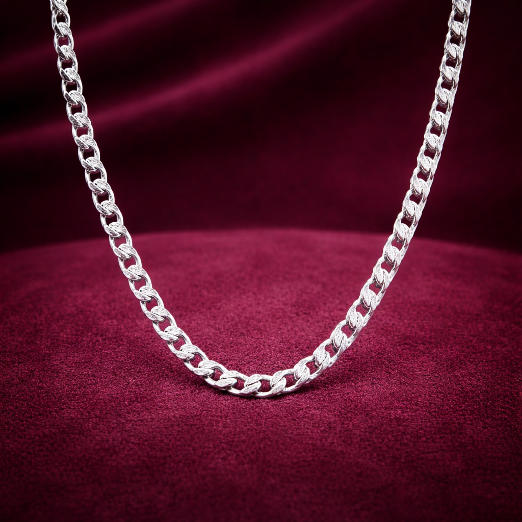 Silver chain necklace on a red fabric background