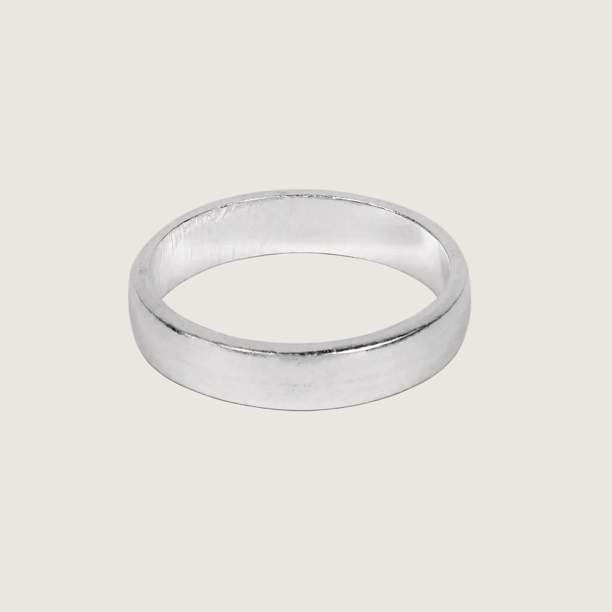 Silver ring on a light beige background