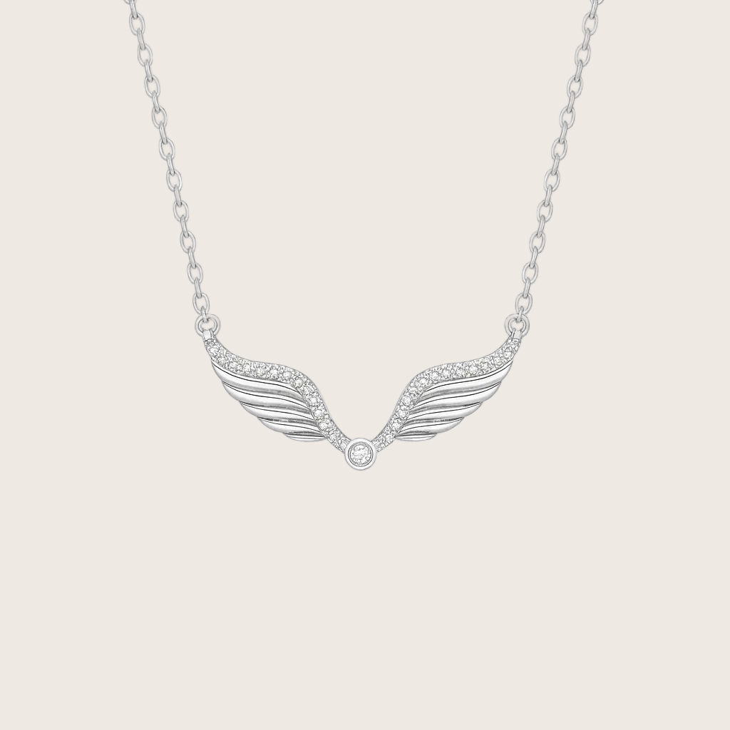 Silver wing-shaped necklace on a white background