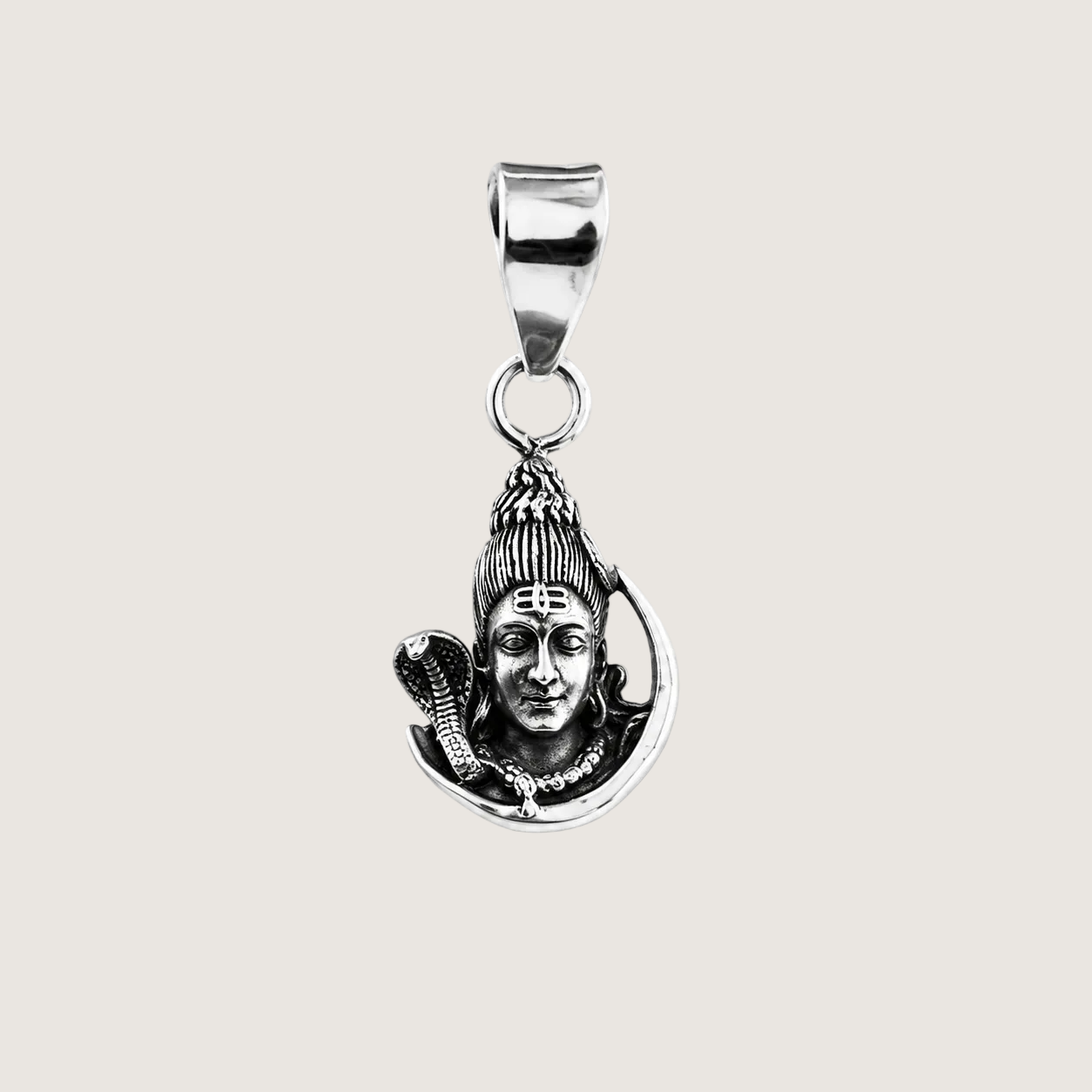 Silver pendant with a face design on a beige background