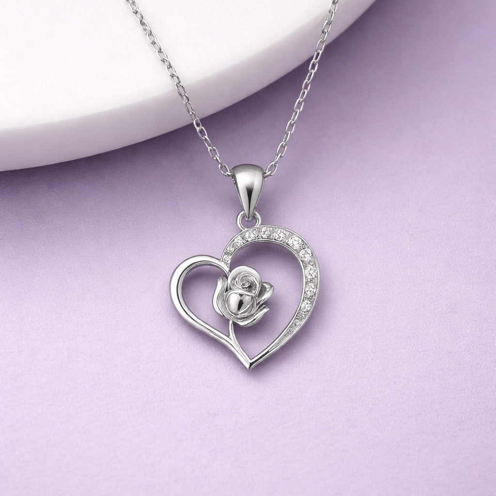 Silver heart-shaped pendant with a rose design on a light purple background