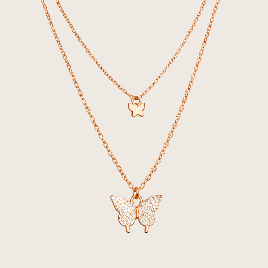 Rose gold butterfly necklace on a white background