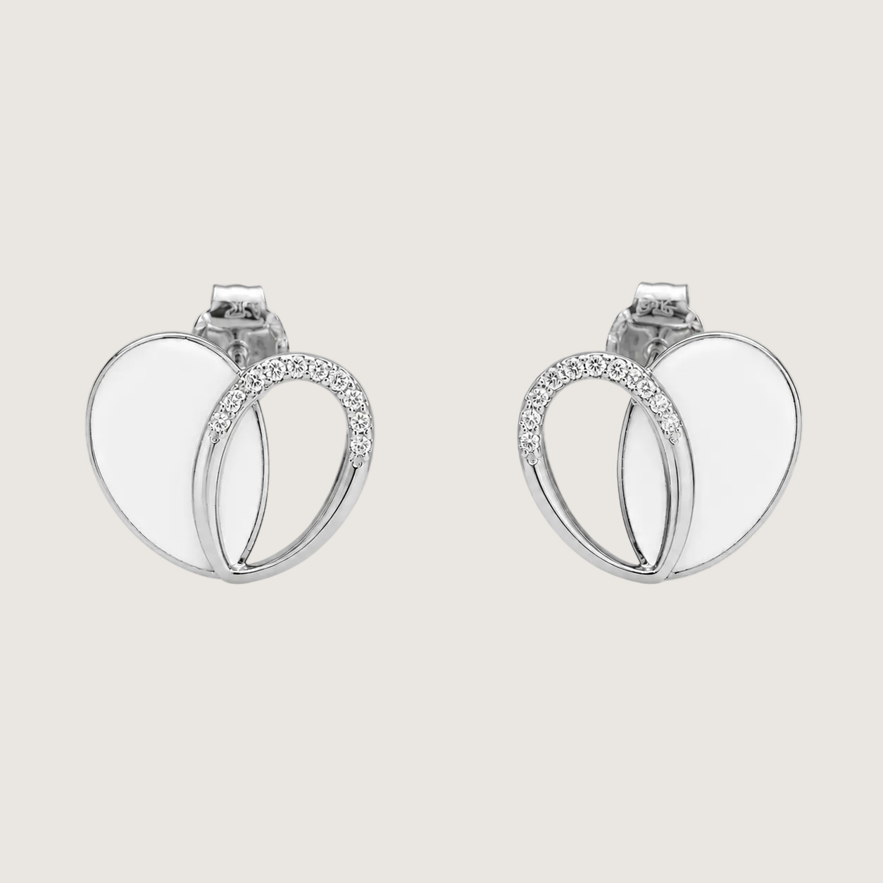Pair of silver hoop earrings with small diamonds on a light beige background